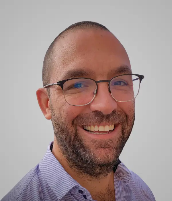 profile photo of Sam gleize with glasses on a grey/blue background